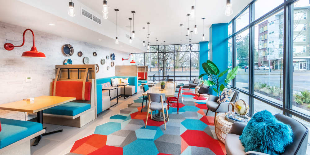 Resident lounge with trendy furniture and city views at Jasper in Portland, Oregon