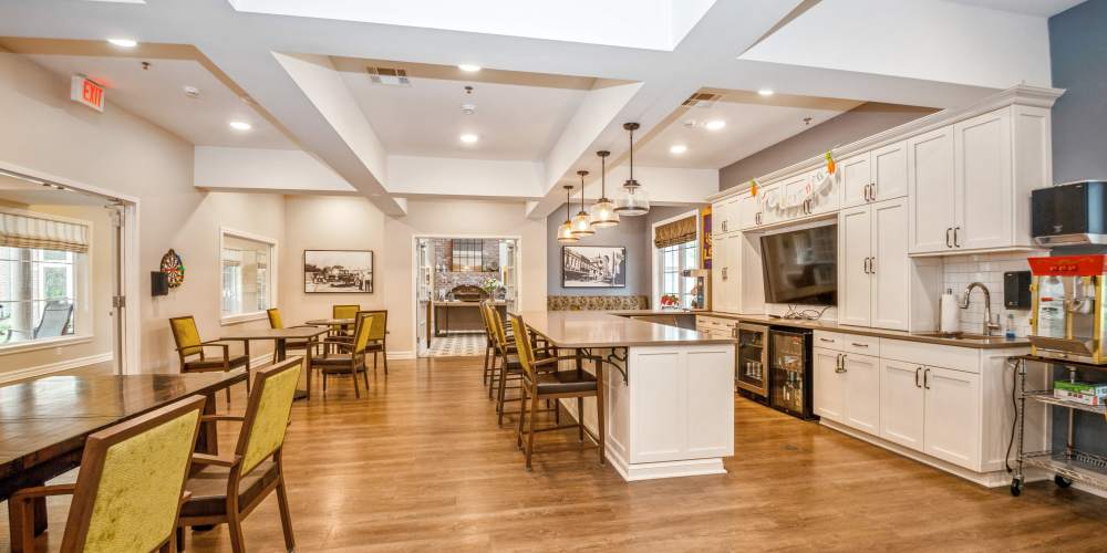 Cafe dining room with a big tv and a popcorn machine at Barclay House of Baton Rouge in Baton Rouge, Louisiana
