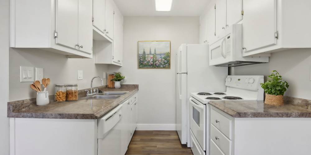 Kitchen with white cabinetry at Bayfair Apartments in San Lorenzo, California