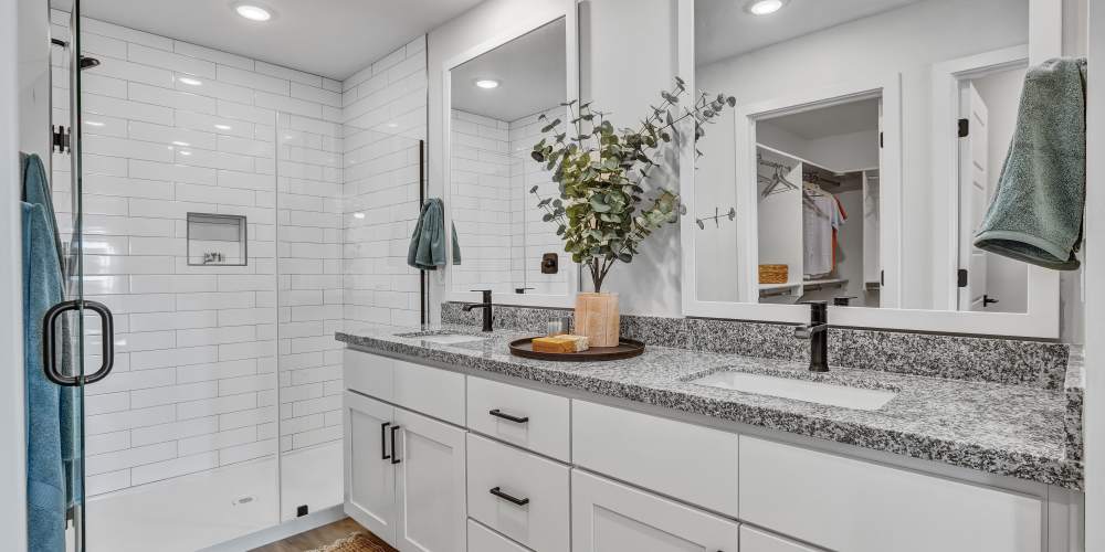 Primary bathroom featuring double sink vanity & walk-in shower at BB Living at The Oaks in Meridian, Idaho