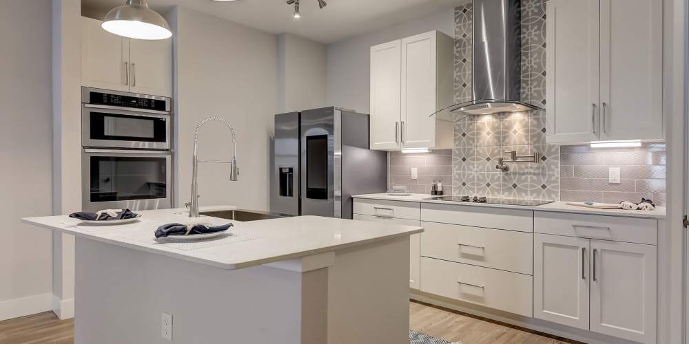 Beautiful kitchen with stainless-steel appliances in a model home at Grande Pointe in Orlando, Florida