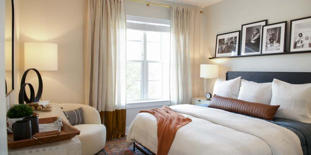 Lavish bedroom with a comfortable bed and a large window at The Prospect in Charlotte, North Carolina