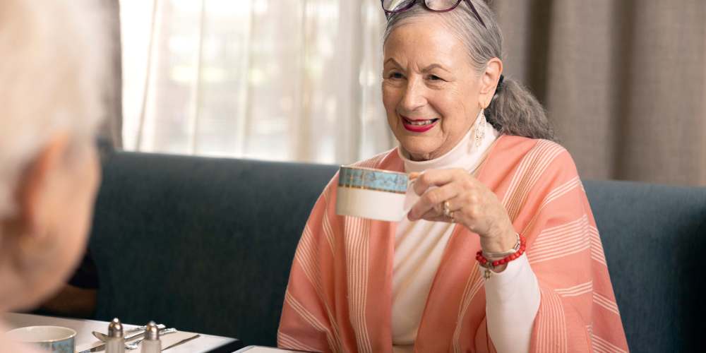 Resident making tea in their home at a QSL Management community