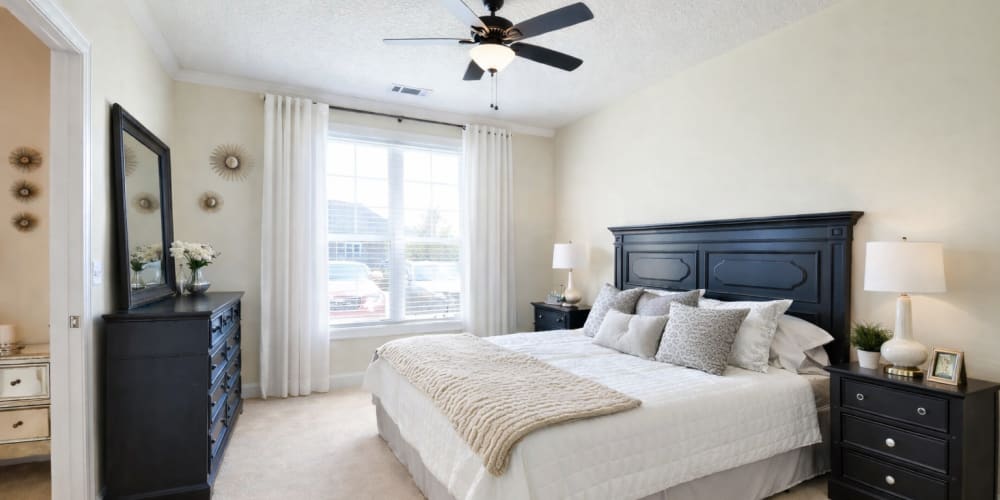 Spacious bedroom with a comfortable bed at Ballantyne Commons of Simpsonville in Simpsonville, South Carolina