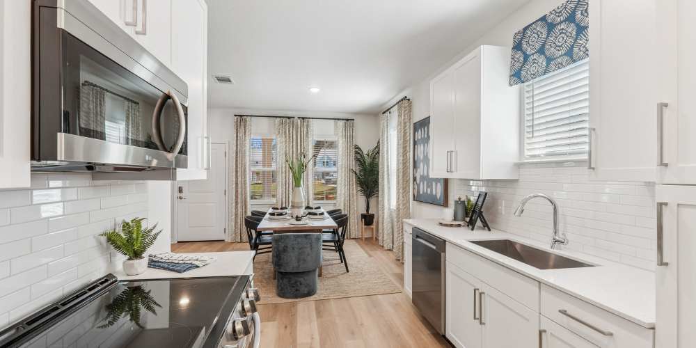 Fully equipped kitchen with stainless steel appliances at fitness center pool amenities large dog friendly Hamlet at Avalon Park in Wesley Chapel, Florida