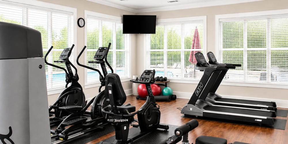 Fitness studio with treadmills and television at Seasons at Cane Creek in Fletcher, North Carolina