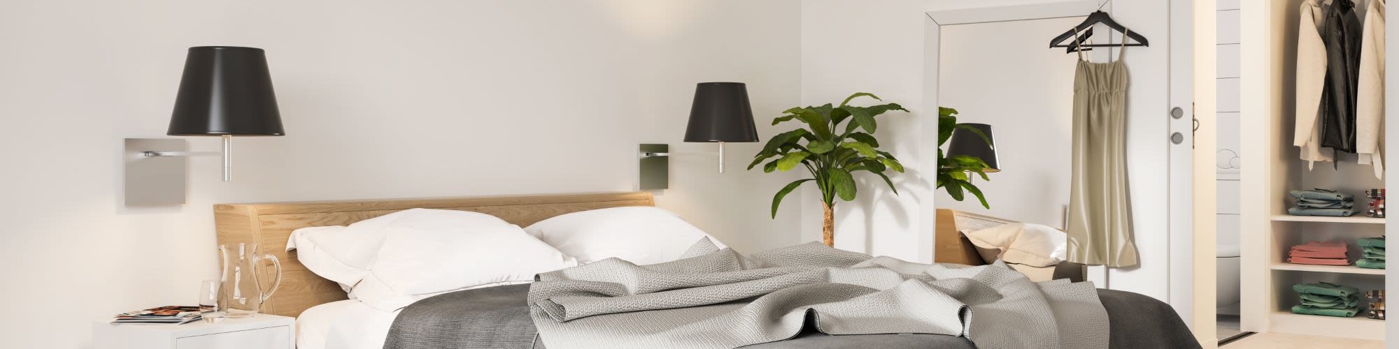 Bedroom with a Large Bed, 2 Lamps and a Mirror at 1221 Vallejo Apartments in Novato, California
