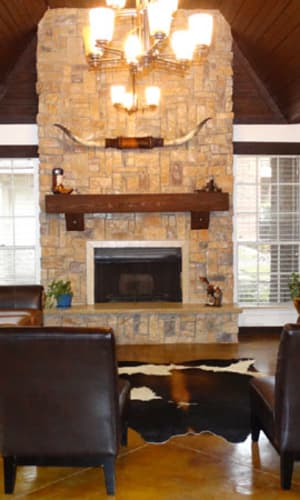 Resident clubhouse with a stone fireplace at Willow Glen in Fort Worth, Texas