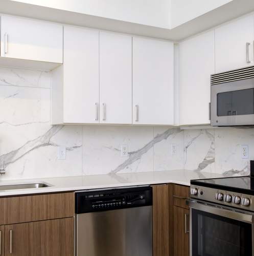 Beautiful kitchen with marble backsplash at 1801L Apartments in Sacramento, California