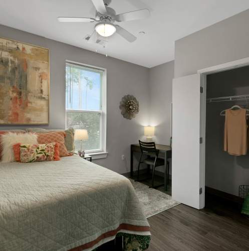 Bedroom with ceiling fan and a view of closet at The Edge in Pensacola, Florida