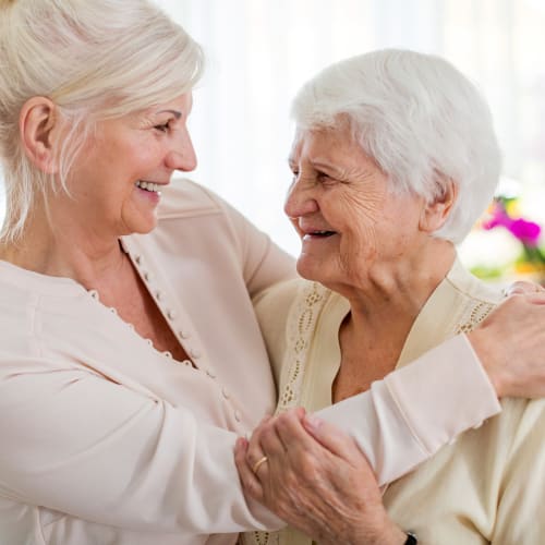 Residents hugging and chatting at Westminster Memory Care in Lexington, South Carolina