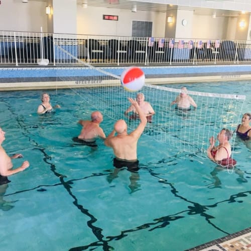 Seniors playing a high-stakes game of volley ball in the pool at The Chamberlin in Hampton, Virginia