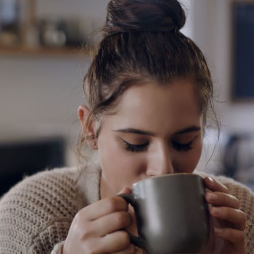 Resident sipping on coffee at IDENTITY Reno in Reno, Nevada