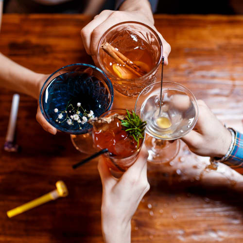 Friends sharing delicious cocktails at a local bar in Atlanta, Georgia near Wellington Point