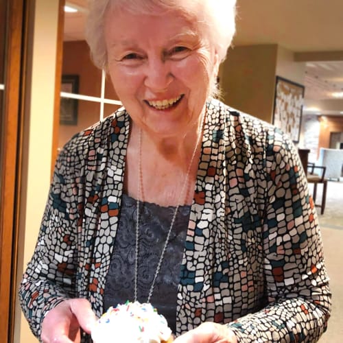 A happy resident with cake at Oxford Senior Living in Wichita, Kansas