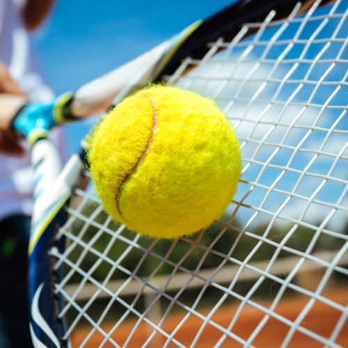 Resident playing tennis at Carrington Point in Douglasville, Georgia