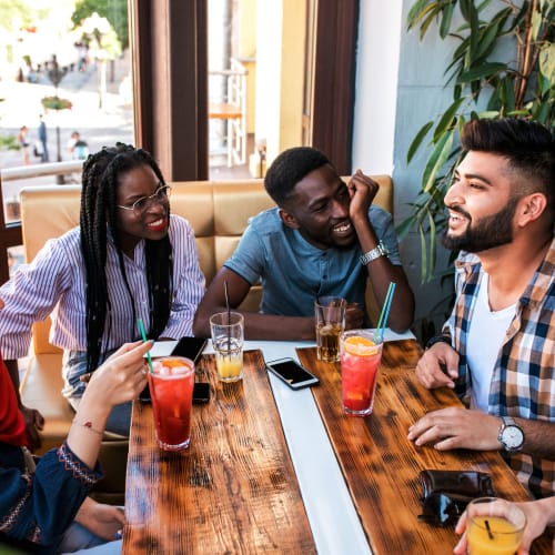 Friends chatting over food and drinks at Forest Cove in Doraville, Georgia