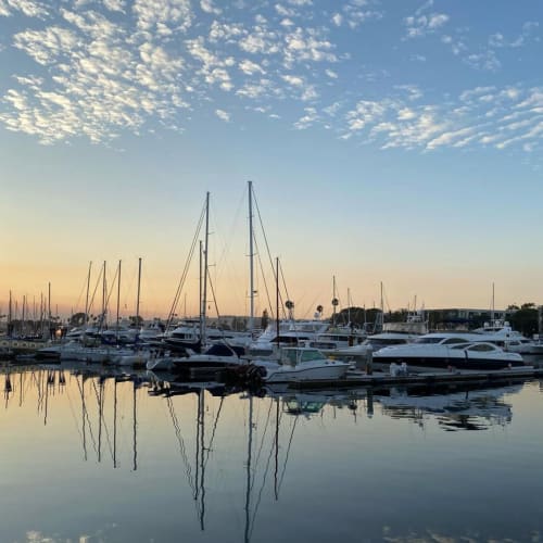 Early morning view of boats in slips at the marina at Marina Harbor in Marina del Rey, California