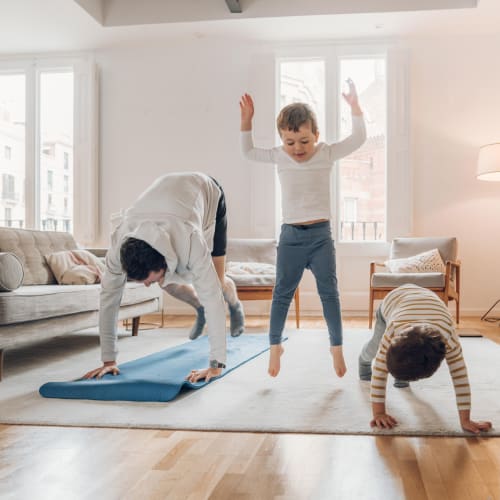 Residents doing yoga together in their living room at Lakeview Residences in Aurora, Illinois