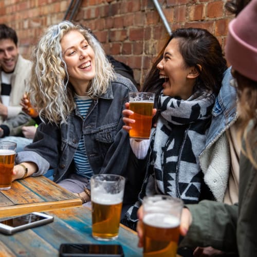Friend chatting over drinks at Mandalane Apartments in Wheeling, Illinois