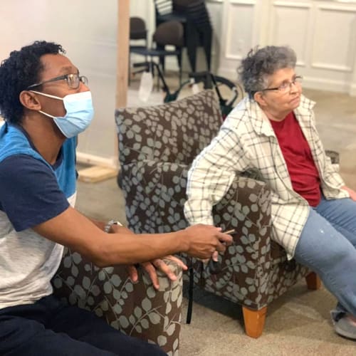Masked team member with a resident at FountainBrook in Midwest City, Oklahoma