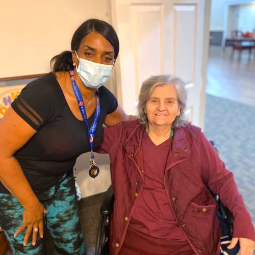 Resident with a masked caretaker at Canoe Brook Assisted Living in Broken Arrow, Oklahoma