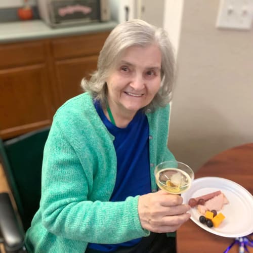 Resident holding a glass of wine at Canoe Brook Assisted Living in Broken Arrow, Oklahoma