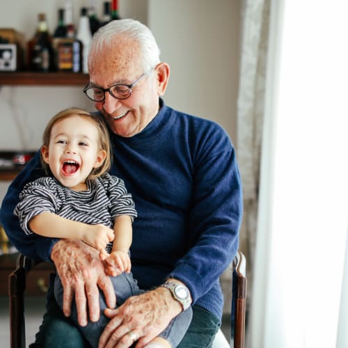 Resident playing with his grandson at Cove West Hartford in West Hartford, Connecticut