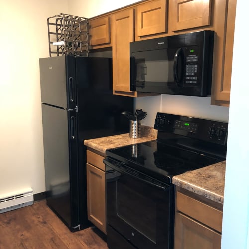 Kitchen with black appliances at Oakwood Apartments in West Carrollton, Ohio