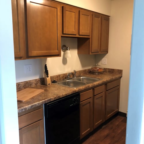Kitchen with wood cabinets at Oakwood Apartments in West Carrollton, Ohio