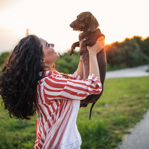 Resident holding her dog at Lofts at Cargill Falls Mill in Putnam, Connecticut