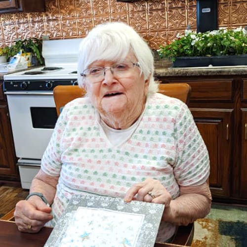 A resident showing off her crafting at Homestead House in Beatrice, Nebraska