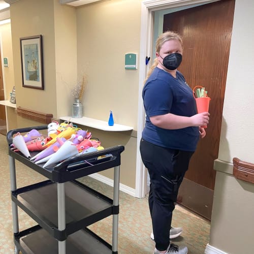 Caretaker bringing gifts to residents at Madison House in Norfolk, Nebraska