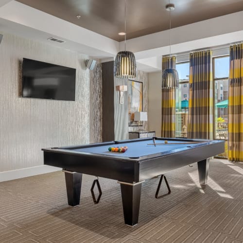 Pool table area with wall mounted television and speakers Marq at Crabtree in Raleigh, North Carolina