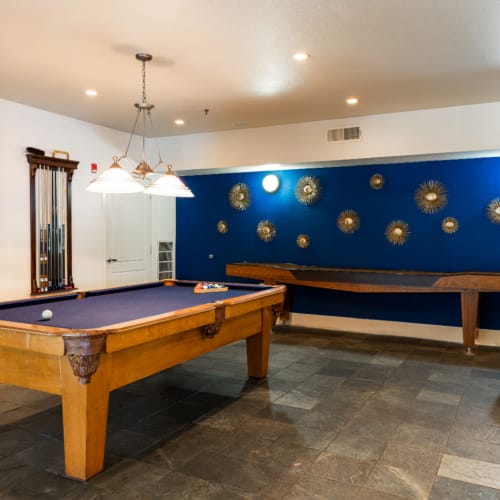 Game room with pool table and shuffle board at Marquis at Texas Street in Dallas, Texas