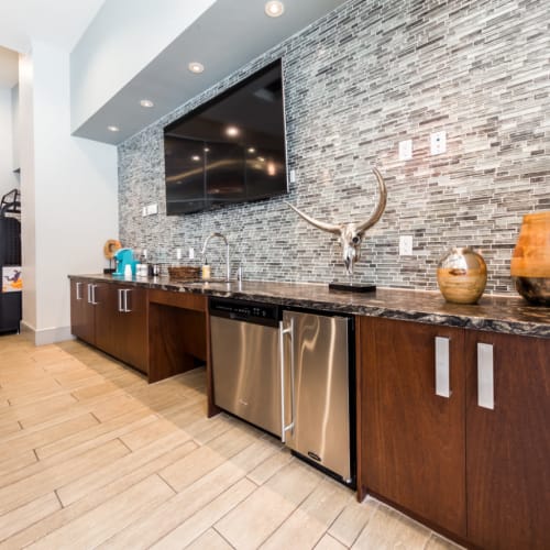 Large wall mounted television in community clubhouse kitchen at Marq on Burnet in Austin, Texas