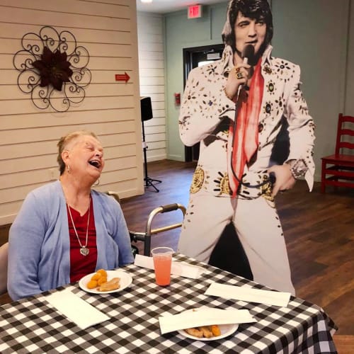 Smiling resident with elvis at Oxford Glen Memory Care at Sachse in Sachse, Texas