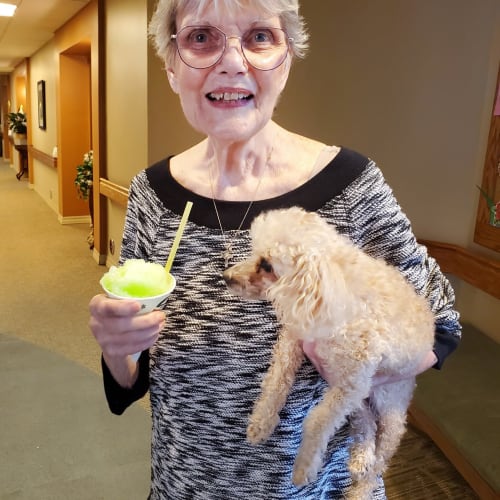 A happy resident with her dog at The Oxford Grand Assisted Living & Memory Care in Wichita, Kansas