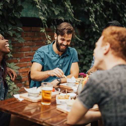 Group of friends enjoying some food and drinks at a popular spot near 1350 Florida in Washington, District of Columbia