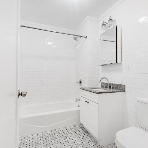 Very sleek bathroom with all white decor at Eastgold NYC in New York, New York