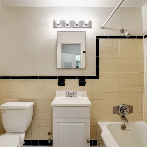 Bathroom vanity with mirror and lots of lighting above at Dorchester House in Washington, District of Columbia