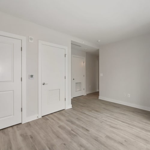 Empty room with light wood style flooring at Madrona Apartments in Washington, District of Columbia