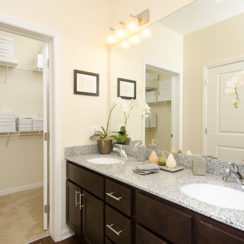 Large bathroom with a spacious closet and huge mirror at The Retreat at Market Square in Frederick, Maryland