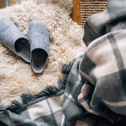 Very cozy blanket and slippers ready to keep you warm on a cold day at Winston House in Washington, District of Columbia