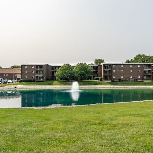 Large pond with a fountain and gazebo at Crescent Ridge Apartments in Crescent Springs, Kentucky