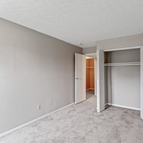 Bedroom with a spacious closet and plush carpeting at Crescent Ridge Apartments in Crescent Springs, Kentucky