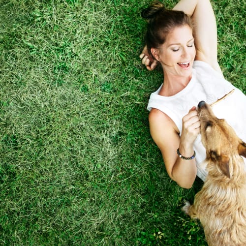 a woman hanging out with her dog at Willoughby Bay in Norfolk, Virginia