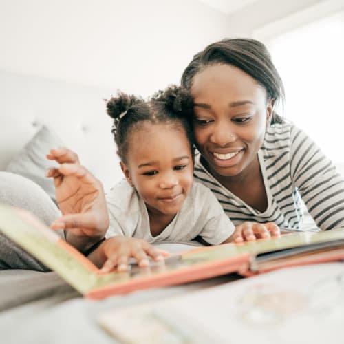 a mother and daughter reading at Willoughby Bay in Norfolk, Virginia