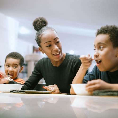 woman eating breakfast with her two sons at Stone Park in Lemoore, California