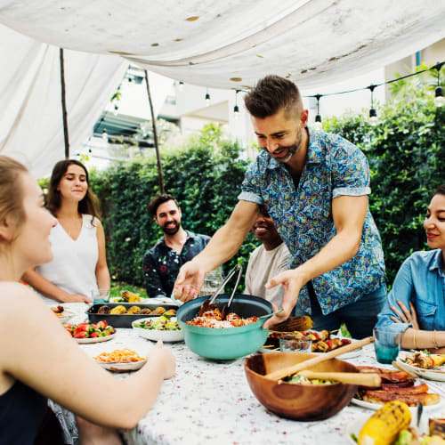 a group if residents having dinner at Stone Park in Lemoore, California